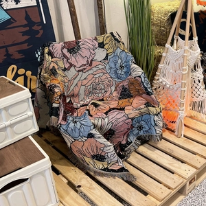 Detail of bohemian floral jacquard throw blanket with fringe and woven texture