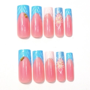 Detail of 3D floral press-on nails with glitter, pearls, and hand-painted flowers