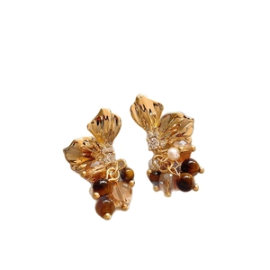 Vintage floral drop earrings with gold petals, tiger eye beads and crystals on white background