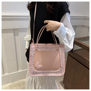 Vue détaillée du sac cabas en peluche rose avec broderie papillon et bandoulière chic