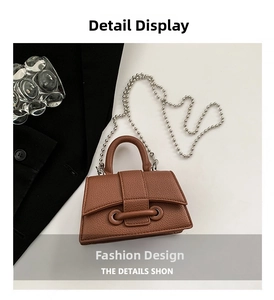 Close-up of brown lychee texture leather mini bag with silver beaded chain strap