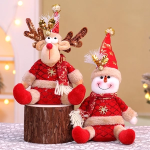 Detail of Christmas reindeer and snowman plush dolls with gold snowflake embroidery