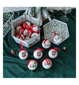 Detailed view of white Christmas baubles with festive reindeer prints in a gift box