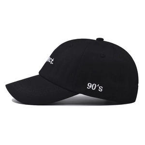 Close-up of black cotton baseball cap with white 90's and rect embroidery details