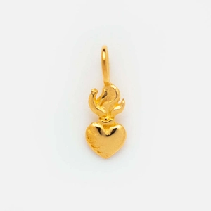 Detailed close-up of a golden heart pendant featuring a unique crown flame top design