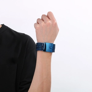 Detail of blue multi-layer braided men's bracelet with a sleek steel clasp on wrist