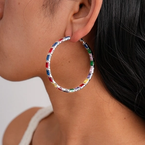 Macro view of silver hoop earrings featuring colorful rainbow rectangular zircon stones