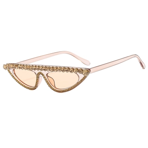 Fashionable cat-eye sunglasses with pink transparent frame and golden crystal rhinestones