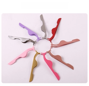 Top view of eight colorful stainless steel eyelash applicators in a radial arrangement