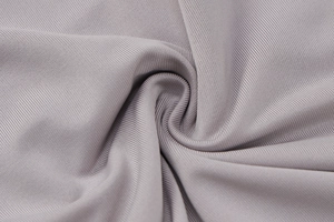 Detailed macro view of gray ribbed knit fabric texture with elastic pleated surface
