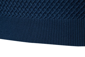 Detail of navy blue knit sweater featuring diamond jacquard pattern and ribbed hem texture