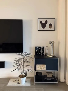 Close-up of a modern blue storage cabinet and silver sparkling water maker in a room