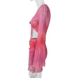 Side view of pink tie-dye mesh set with V-neck lace-up top and ruched mini skirt