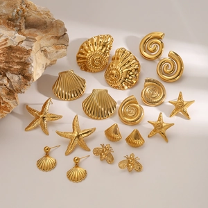 Golden stainless steel earring set featuring starfish and shell designs on natural rock base