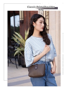 Street style shot of a woman wearing a vintage patterned brown crossbody bucket bag