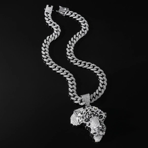 Macro detail of iced-out silver leopard head pendant with sparkling cubic zirconia on Cuban chain