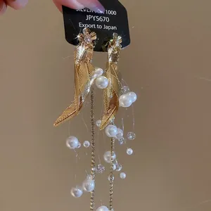 Elegant gold flower and leaf earrings with long pearl tassels and sparkling zircon accents