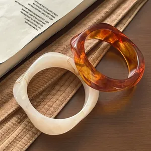 Detail of resin bangle set with dark amber tortoiseshell and marble textures