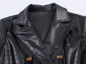 Close-up of black PU leather trench coat with crocodile texture and classic lapel