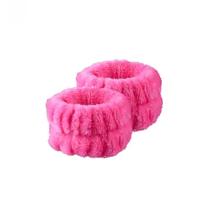 Detail of pink coral fleece face washing wristbands with absorbent elastic design