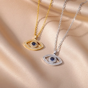 Detailed macro view of Evil Eye necklace pendants in gold and silver with blue stones
