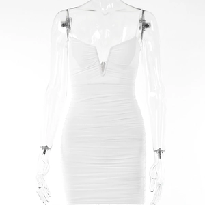 Close-up detail of white bodycon mini dress featuring V-neckline and ruched fabric texture