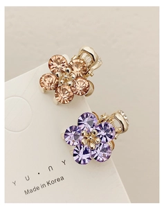 Close-up of elegant crystal flower mini hair claws in champagne and lavender on display card