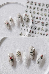 Detailed view of 5D embossed floral nail stickers featuring roses and vintage frames