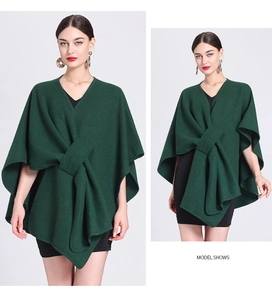 Detail view of a dark green wool blend poncho coat with asymmetric hem and knotted front