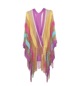 Close-up of colorful rainbow striped knit shawl with long bohemian fringe details