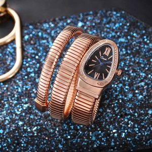 Detail of rose gold snake bracelet watch featuring a black dial and crystal-set bezel