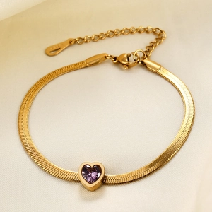 Detail of 14K gold snake chain bracelet featuring a purple heart-shaped stone pendant