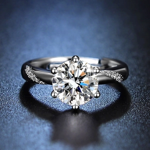Macro shot of a classic six-prong solitaire ring with side stone accents on blue background