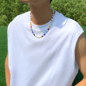Minimalist colorful glass flower beaded necklace with pearls worn on a female model