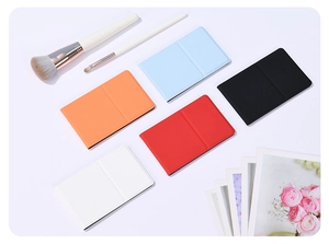 Foldable vanity mirrors in five colors including black, red, and blue with PU leather covers