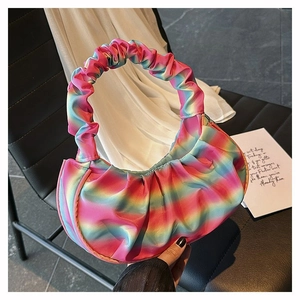 Detailed close-up of rainbow gradient pleated shoulder bag with soft silk texture