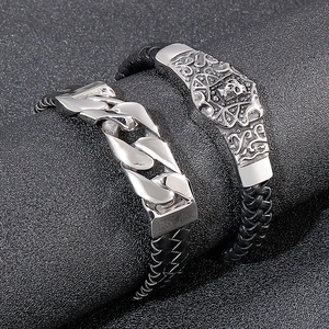 Polished silver Cuban link and skull charm bracelets with black braided leather cords