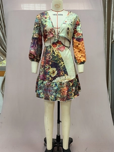 Detail of bohemian floral maxi dress featuring waist cutouts and a central metal ring connector