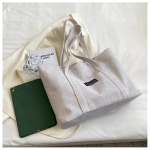 Close-up of canvas tote bag texture with aesthetic book and minimalist props