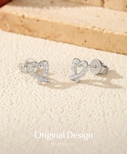 Macro shot of S925 sterling silver heart earrings with sparkling moissanite stones