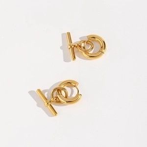 Detailed view of gold metal hoop earrings with a modern nested T-bar geometric design
