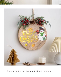 Wooden Merry Christmas sign hanging above candles and lamp for festive home wall decor