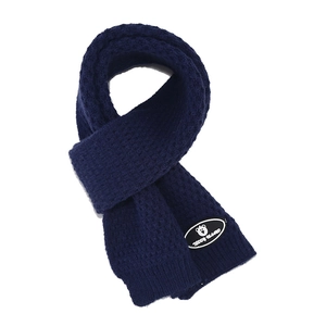 Detail of navy blue knitted scarf with teddy island bear logo and waffle weave pattern