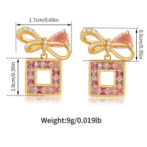 Detail view of pink bow earrings with size labels and square pendant weight info