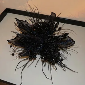 Elegant black fabric flower hair claw clip with feathers and pearls for hair styling