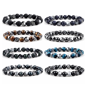 Flat lay of multiple woven bracelets with natural tiger eye and faceted hematite stones