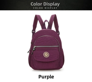 Detail view of purple nylon backpack showing front pockets and metal zipper details