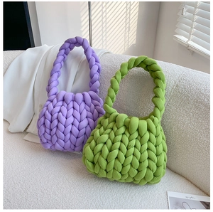 Detail of purple and green chunky yarn crochet handbags with unique woven texture on sofa