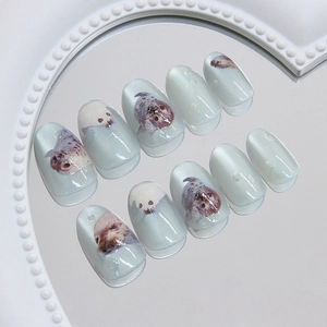 Cat eye ocean blue press on nails featuring cute cartoon seal patterns and shimmer