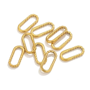 Macro shot of oval gold metal jewelry connectors with spiral texture for DIY making